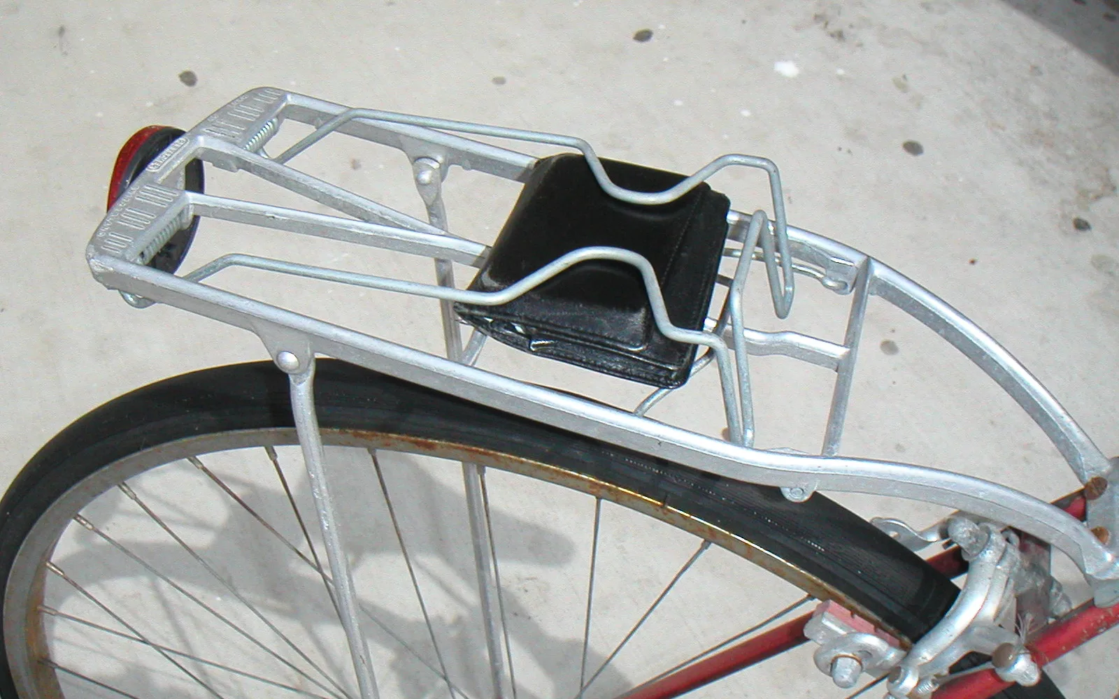 A metal bicycle rack with multiple bicycles parked, showing the infrastructure that supports cycling as transportation